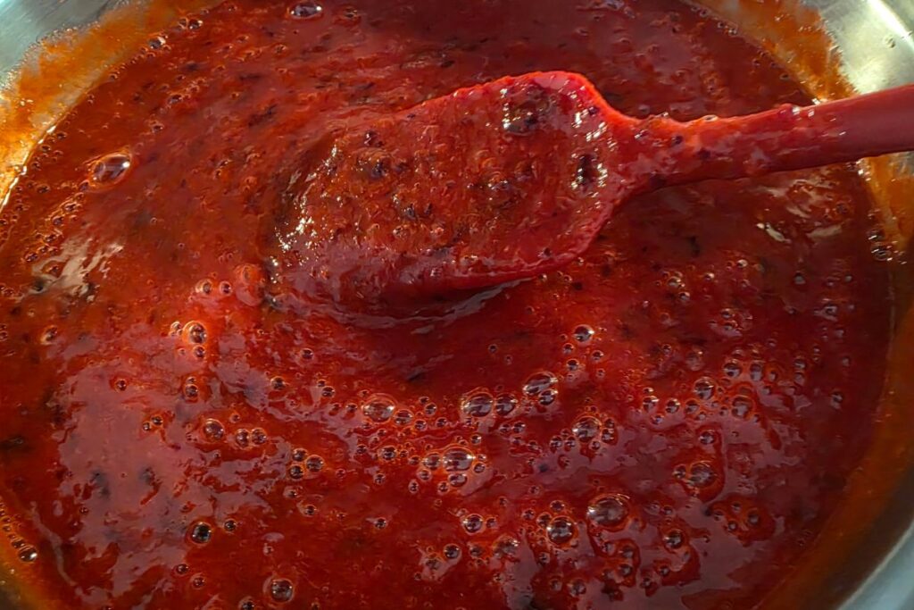 making spiced plum jam in pot